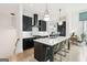 Sleek kitchen with a large island, white countertops, black cabinetry, and gold bar stools at 698 Eustace Se St, Atlanta, GA 30315