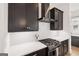 Modern kitchen features dark cabinetry, white countertops, and stainless steel appliances, and white tile backsplash at 698 Eustace Se St, Atlanta, GA 30315
