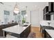 Bright, modern kitchen with a large island, white counters, and stainless steel appliances overlooking the living area at 698 Eustace Se St, Atlanta, GA 30315