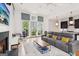 Bright, open-concept living space with fireplace, large windows, and access to modern kitchen at 698 Eustace Se St, Atlanta, GA 30315