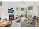 Open-concept living room with modern furnishings, a cozy fireplace, and large windows at 698 Eustace Se St, Atlanta, GA 30315