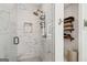 Modern walk-in shower with marble tiling and elegant bronze hardware at 698 Eustace Se St, Atlanta, GA 30315