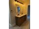 Bright bathroom featuring a double vanity with modern fixtures, two mirrors, and wood-look cabinetry at 1053 Metropolitan Parkway Southwest Sw Pkwy, Atlanta, GA 30310