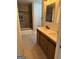 Modern bathroom featuring a double sink vanity, wood-look cabinets, and a shower-tub combo with glass door at 1053 Metropolitan Parkway Southwest Sw Pkwy, Atlanta, GA 30310
