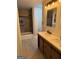 Modern bathroom featuring a double sink vanity, wood-look cabinets, and a shower-tub combo with glass door at 1053 Metropolitan Parkway Southwest Sw Pkwy, Atlanta, GA 30310