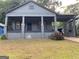 Charming bungalow style house featuring a covered front porch and a gray painted exterior at 1053 Metropolitan Parkway Southwest Sw Pkwy, Atlanta, GA 30310