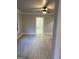 Bright open living room with light wood flooring leading into a hallway, featuring neutral walls and white trim at 1053 Metropolitan Parkway Southwest Sw Pkwy, Atlanta, GA 30310