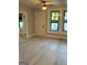 Bright living room with light wood flooring, neutral walls, and lots of natural light from three windows at 1053 Metropolitan Parkway Southwest Sw Pkwy, Atlanta, GA 30310