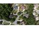 An aerial view of a residential neighborhood with lush green trees and cul-de-sacs at 200 Long Needle Ct, Sugar Hill, GA 30518