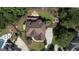 Aerial view of a backyard featuring a pool, stone fire pit, garden, and a play area at 200 Long Needle Ct, Sugar Hill, GA 30518