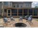 Home with outdoor fireplace, stone patio and screened in porch at 200 Long Needle Ct, Sugar Hill, GA 30518