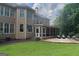 Back of house with screened in porch and outdoor patio seating area at 200 Long Needle Ct, Sugar Hill, GA 30518
