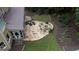 Aerial view of a backyard featuring a stone patio with fire pit, seating, and lounge chairs at 200 Long Needle Ct, Sugar Hill, GA 30518
