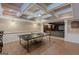 Finished basement with coffered ceilings, tile flooring, and a ping pong table, great for recreation at 200 Long Needle Ct, Sugar Hill, GA 30518