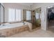 Bathroom features a glass enclosed shower, soaking tub, and tiled floor at 200 Long Needle Ct, Sugar Hill, GA 30518