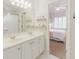 Bathroom with a double sink vanity, modern decor, and access to the bedroom at 200 Long Needle Ct, Sugar Hill, GA 30518