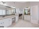 Bathroom showcasing dual sinks, granite counters, tiled floors and an open doorway to bedroom at 200 Long Needle Ct, Sugar Hill, GA 30518