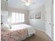 Bright bedroom featuring a ceiling fan, shutters on the windows, and neutral-toned decor at 200 Long Needle Ct, Sugar Hill, GA 30518