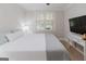 Bright bedroom with plantation shutters, neutral tones, and a ceiling fan at 200 Long Needle Ct, Sugar Hill, GA 30518