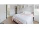 Bright bedroom featuring a built-in bookshelf, soft decor, and a hallway leading to the bathroom at 200 Long Needle Ct, Sugar Hill, GA 30518
