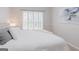 Bright bedroom featuring shutters, decor, neutral paint tones, and soft pillows at 200 Long Needle Ct, Sugar Hill, GA 30518