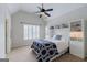 Bedroom features a vaulted ceiling, built-in shelving unit, carpeted floors, and a ceiling fan at 200 Long Needle Ct, Sugar Hill, GA 30518