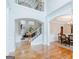 Open foyer with hardwood floors, soaring ceilings, and views to living and dining areas at 200 Long Needle Ct, Sugar Hill, GA 30518