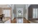 Grand foyer with gleaming hardwood floors, and elegant trimwork, leading to other rooms at 200 Long Needle Ct, Sugar Hill, GA 30518