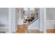 Entryway featuring hardwood floors and staircase, offering views into living spaces at 200 Long Needle Ct, Sugar Hill, GA 30518