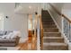 Inviting foyer with hardwood floors, staircase, and views into the living room at 200 Long Needle Ct, Sugar Hill, GA 30518