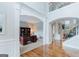 Bright foyer boasts hardwood floors, archways, and an open view to the office and living spaces at 200 Long Needle Ct, Sugar Hill, GA 30518