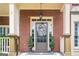Elegant front entrance with glass paneled door, wreath, and manicured potted plants at 200 Long Needle Ct, Sugar Hill, GA 30518