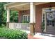 Inviting front porch featuring classic columns, decorative plants, and a welcoming wreath at 200 Long Needle Ct, Sugar Hill, GA 30518