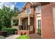 Beautiful brick home with a charming front porch and detailed architectural features at 200 Long Needle Ct, Sugar Hill, GA 30518