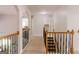 Upstairs hallway with railing overlooking the living room at 200 Long Needle Ct, Sugar Hill, GA 30518