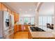 Stylish kitchen showcasing stainless steel appliances, granite counters, and wooden cabinets at 200 Long Needle Ct, Sugar Hill, GA 30518