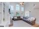 Spacious living room with tall windows and a large comfortable sectional sofa at 200 Long Needle Ct, Sugar Hill, GA 30518