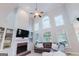 Vaulted-ceiling living room with built-in shelving, a fireplace, and plenty of natural light at 200 Long Needle Ct, Sugar Hill, GA 30518