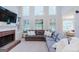 Spacious living room with fireplace, built-ins, and many windows for natural light at 200 Long Needle Ct, Sugar Hill, GA 30518
