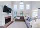 Inviting living room with a brick fireplace and a comfortable sectional sofa at 200 Long Needle Ct, Sugar Hill, GA 30518