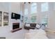 Inviting living room features a vaulted ceiling, fireplace, built-ins, and many windows at 200 Long Needle Ct, Sugar Hill, GA 30518