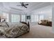 Spacious main bedroom with a tray ceiling, lots of natural light, and a sitting area at 200 Long Needle Ct, Sugar Hill, GA 30518