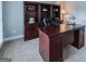 This office features a large desk with a built-in bookcase and neutral carpeting at 200 Long Needle Ct, Sugar Hill, GA 30518