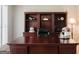 Well-lit office showcases a spacious desk, built-in bookcase, and plush carpeting at 200 Long Needle Ct, Sugar Hill, GA 30518