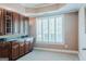 Office area with built-in cabinets, ample counter space, and natural light streaming through plantation shutters at 200 Long Needle Ct, Sugar Hill, GA 30518