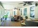 Relaxing screened porch with wooden floors and ceiling fans, perfect for enjoying the outdoors comfortably at 200 Long Needle Ct, Sugar Hill, GA 30518