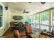 Spacious screened porch provides ample seating, a fire table, and views of the green backyard at 200 Long Needle Ct, Sugar Hill, GA 30518