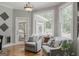 Inviting sitting area with large windows offering scenic views of the outdoors at 200 Long Needle Ct, Sugar Hill, GA 30518