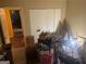 Bedroom featuring a double closet and items scattered on the floor, with signs placed on a table at 2009 Oak Park Ln, Decatur, GA 30032