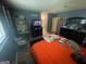 Bedroom showcasing a TV on a dresser, a queen bed, a desk with accessories, and a closet at 2009 Oak Park Ln, Decatur, GA 30032